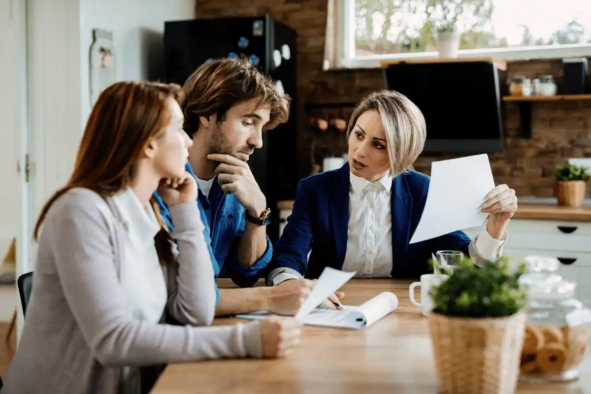 “funeral home buyers discussing financing and real estate loan documents with lender”